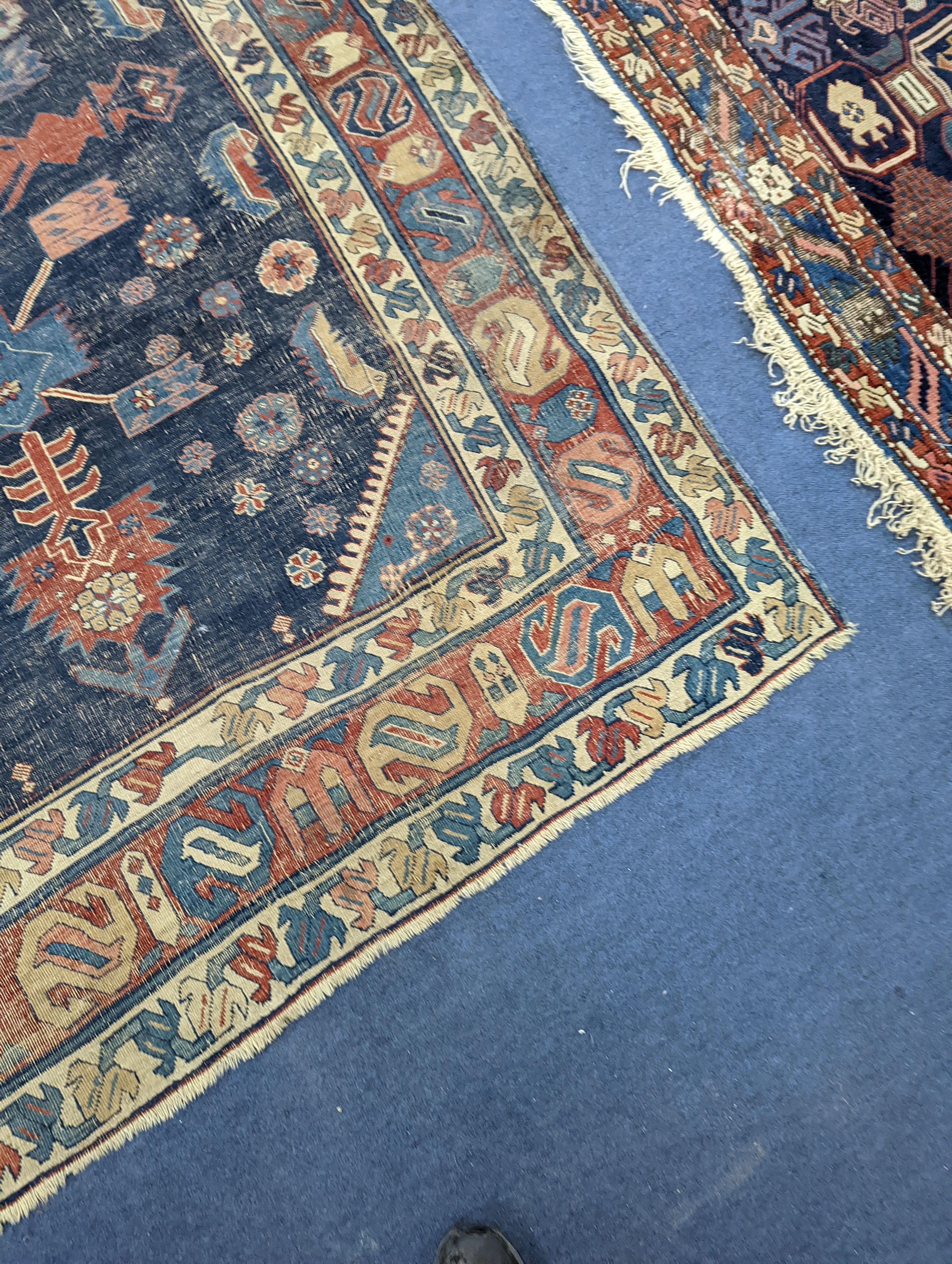 An antique Caucasian blue ground rug (worn), 200 x 148cm